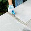 grout the joints to clad concrete steps in stone