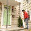 person replacing porch post
