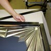 attaching the trim to the plywood chalkboard frame
