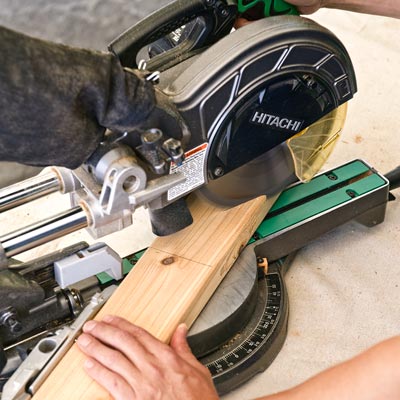 cutting the bottom end of a lamppost with a compound miter saw