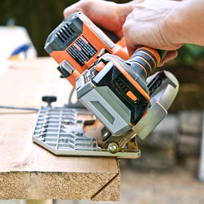 ripping a bevel with a circular saw with the blade set at a 45 degree angle