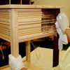 staining the side table with a rag