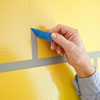 removing the painter's tape to reveal the 