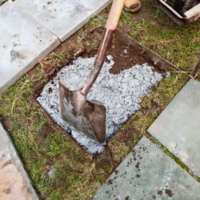 filling setting bed for paver with stone dust for a stable base in stone stepping path