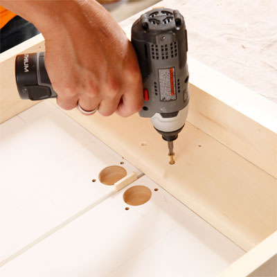 Screw the Bed Frame to the Cabinet Doors to build a murphy bed for your dog
