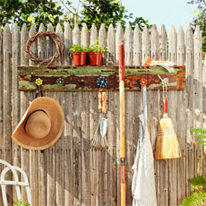 finished project from How to Build a Spigot-Handle Tool Rack installed on a picket fence