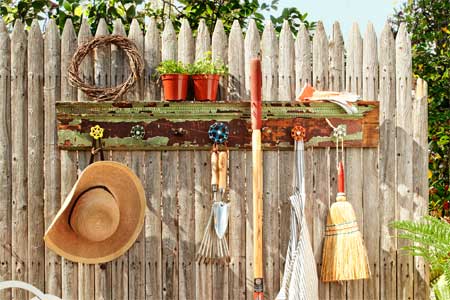 finished project from How to Build a Spigot-Handle Tool Rack installed on a picket fence