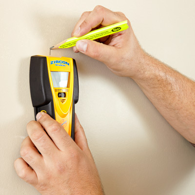 finding and marking a stud in the wall with a stud finder