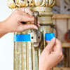 painter's tape marks the diameter of an antique column for hanging hooks
