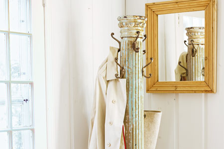 a coat rack made from a salvaged antique column