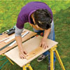 Position the scrap against one of the lines on the plywood