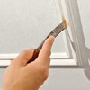 Using a small putty knife fill any nail holes with putty
