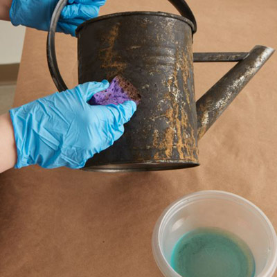 give a watering can a faux rust coating apply rust solution over tacky paint
