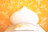 step by step stencil on wall surrounding headboard