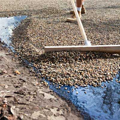 Spread the Stone to Install a Low-Maintenance, All-Gravel Driveway