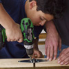 boy attaching the hinges to build an easel
