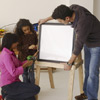Family mounting the boards to build an easel 