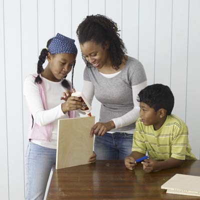 family helps to glue up the boards