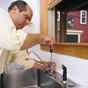 unscrewing a single-handled kitchen faucet with a cartridge under the handle