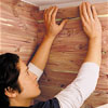 Hands placing the topmost course to the wall