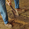 excavating soil to build a brick walkway