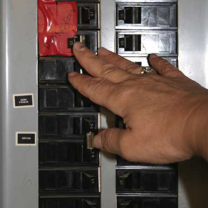 woman turning power off 