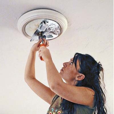 unscrew the nuts on the lighting fixture
