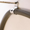 man inserting tube spring in water supply