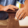 man sanding the wood handrail