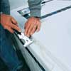 scraping off old caulk from tub surround with 5-in-1 tool