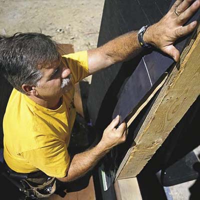 Tom Silva installing a window