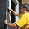 Tom Silva installing a window