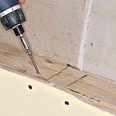 Driving screws into the blocking, at an angle.