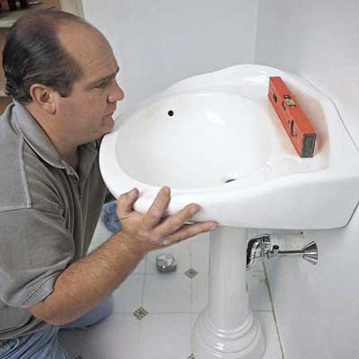 Richard Trethewey mounting a pedestal sink