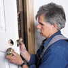 Tom Silva mounting the latch hardware of a prehung door