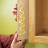 Covering exposed sides of cabinet, using plywood and glue.