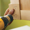 Attaching knobs and pulls and finishing the drawers.