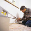 Tom Silva taking measurements for baseboard installing 