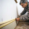 Tom Silva installing baseboard