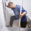 Lifting a shower doo into its base track