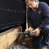 Tom Silva attaching the ledger of an on-grade deck