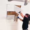 Mark the skylight opening and cut out rough opening with a drywall saw