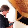 Drive nails through the plywood roof sheathing in each of the four corners of the rough opening