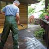 wash the deck and railings with a garden hose or pressure washer