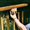 apply the stain full-strength with a synthetic filament brush to the deck railings