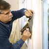 Tom Silva trimming out a window