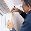 Tom Slva trimming out a window