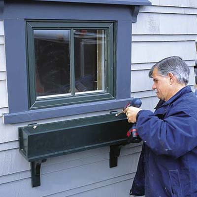 Fastening the window box to its brackets