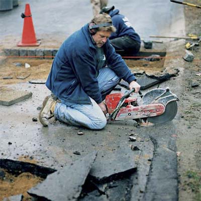 cut through the blacktop with gas-powered cutoff saw