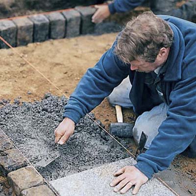 spreading the setting mix for installing the field of pavers